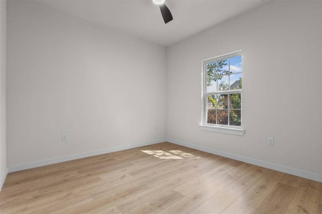 333 Levant Avenue, Dallas, TX 75217 Wood-finish flooring, white walls, single window, and a ceiling fan