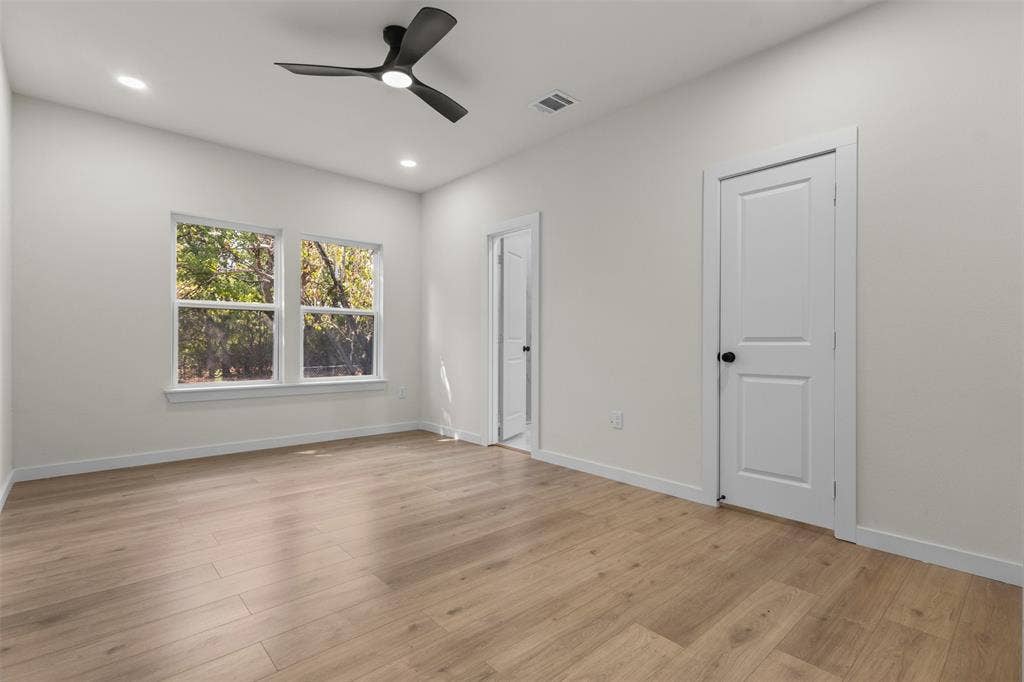 333 Levant Avenue, Dallas, TX 75217 Light wood-finish flooring, white walls, and a modern ceiling fan with integrated lighting
