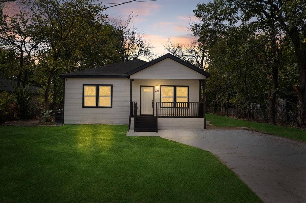 333 Levant Avenue, Dallas, TX 75217 Contemporary single-story residence with a black-trimmed roofline and light-colored siding
