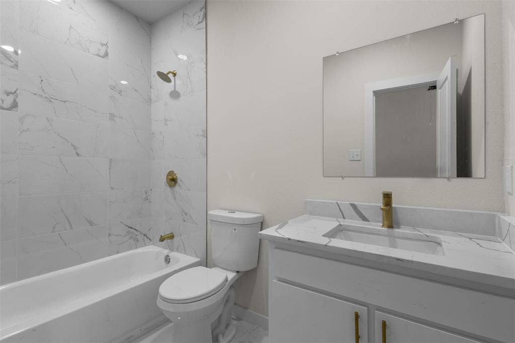 333 Levant Avenue, Dallas, TX 75217 White vanity with integrated sink and gold-tone faucet