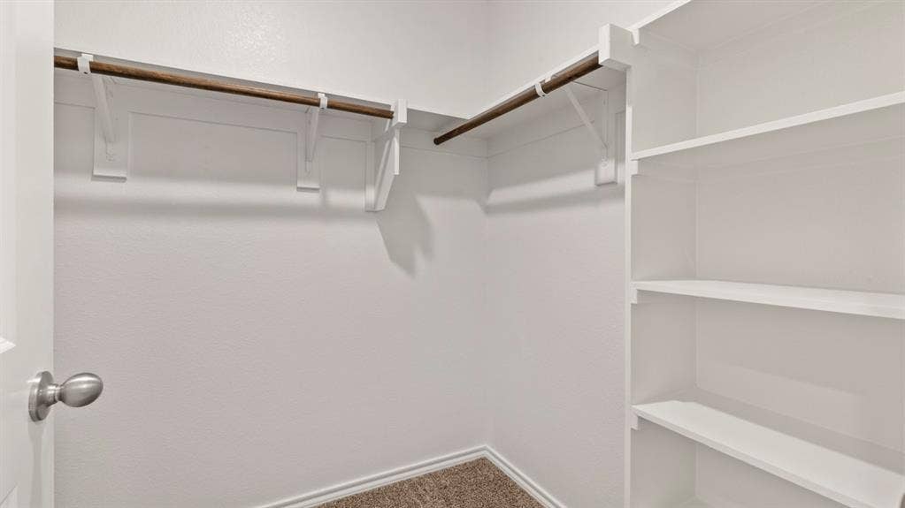 193 Brooks Street, Bullard, TX 75757 Built-in shelving, two clothing rods, and textured wall finish