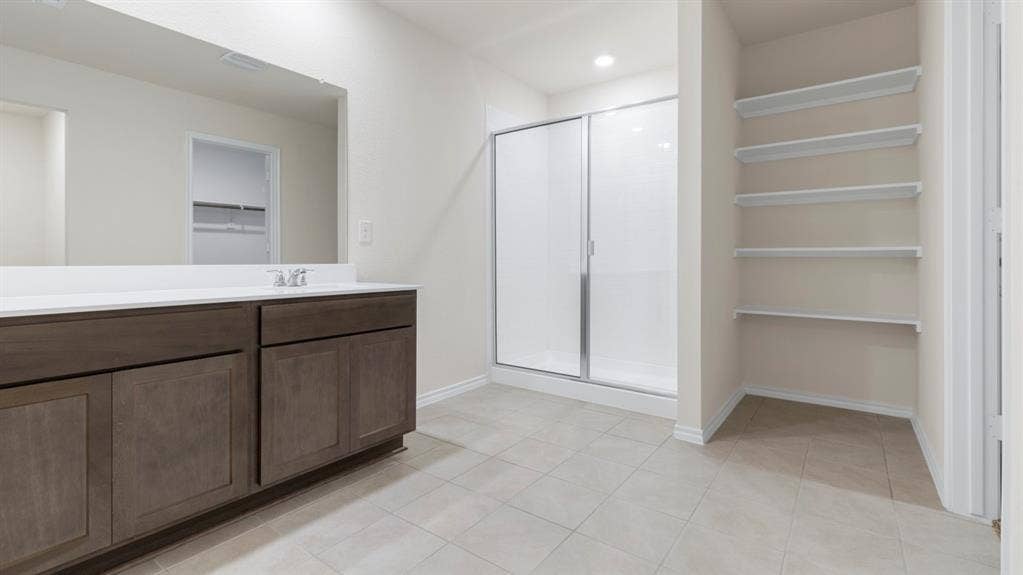 205 Brooks Street, Bullard, TX 75757 Vanity with a light-colored countertop, integrated sink, and an expansive mirror