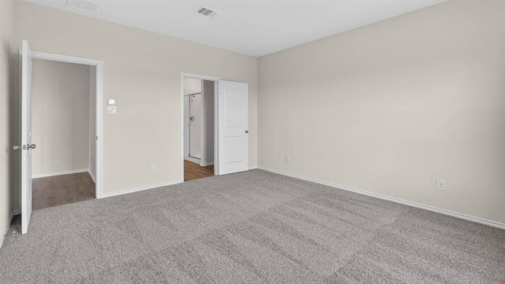 201 Brooks Street, Bullard, TX 75757 Spacious room with light gray carpeting and neutral wall tones