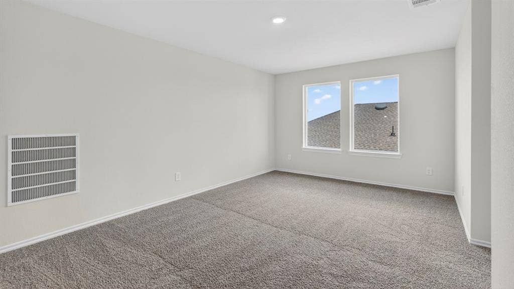 201 Brooks Street, Bullard, TX 75757 Neutral tone wall paint, recessed ceiling lighting, light gray carpet, and two large windows