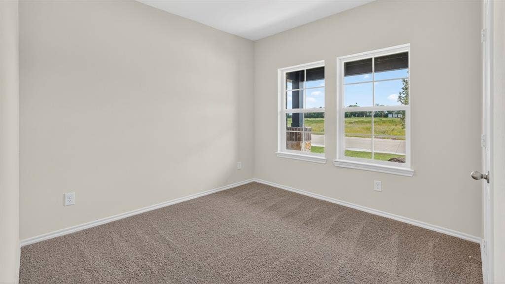 201 Brooks Street, Bullard, TX 75757 Neutral paint palette, two large windows, and plush carpet flooring