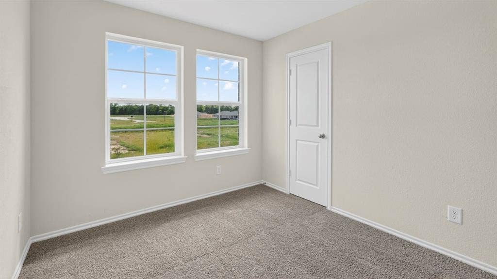201 Brooks Street, Bullard, TX 75757 Neutral wall color, textured wall finish, and two double-hung windows with white frames