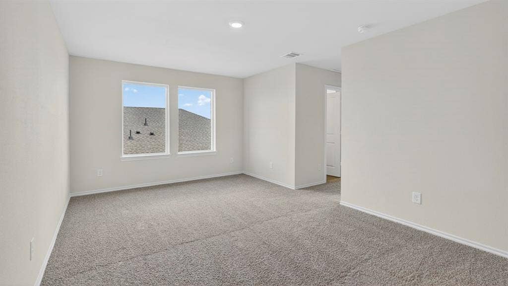 201 Brooks Street, Bullard, TX 75757 Spacious room featuring neutral carpeting, light-toned wall finishes, recessed lighting, and two windows