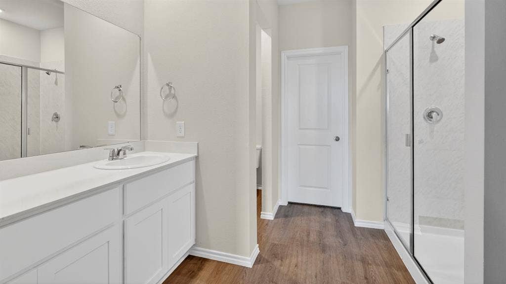 201 Brooks Street, Bullard, TX 75757 White vanity with integrated sink, chrome faucet, and expansive mirror