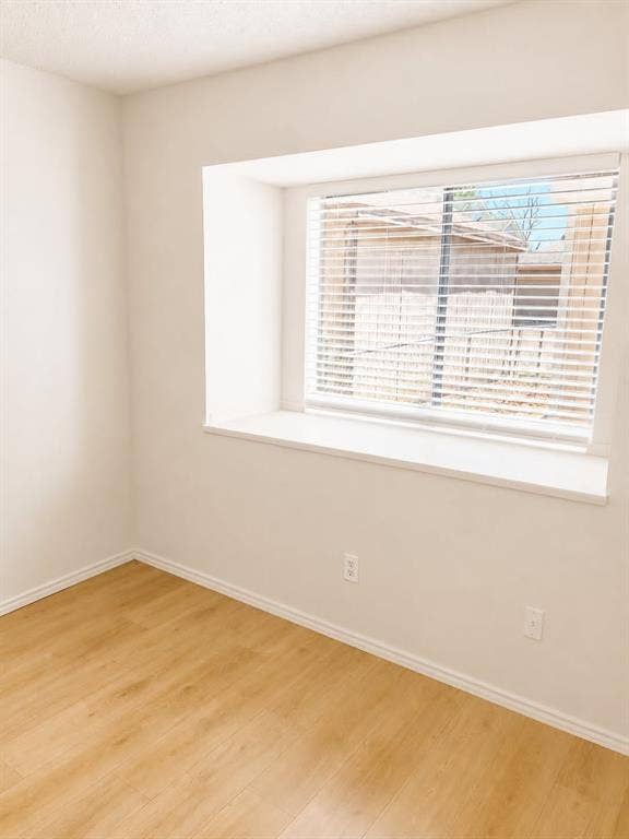 4952 Berridge Lane, Dallas, TX 75227 Light wood-finish flooring with white walls and trim