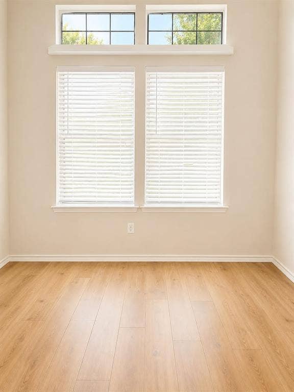 4952 Berridge Lane, Dallas, TX 75227 Wood-finish flooring with white trim and neutral wall tones