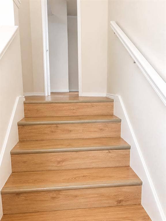 4952 Berridge Lane, Dallas, TX 75227 Wood-finish stair treads with white risers and handrail