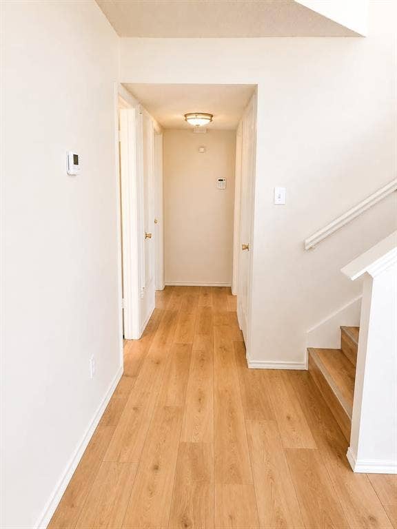 4952 Berridge Lane, Dallas, TX 75227 Wood-finish flooring throughout the hallway and staircase
