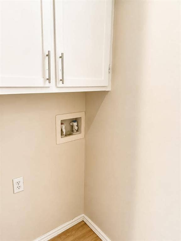 4952 Berridge Lane, Dallas, TX 75227 White shaker-style upper cabinetry with brushed nickel hardware, light wood-finish flooring, and a neutral wall color
