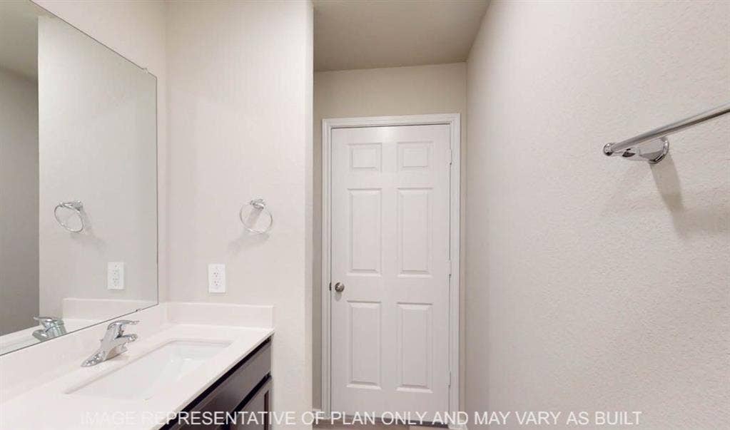 10217 Neptune Court, Waco, TX 76708 Vanity with an integrated sink, polished chrome faucet, and a large wall-mounted mirror