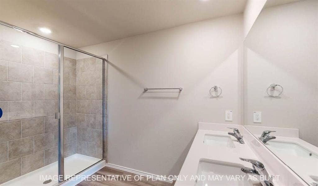 10217 Neptune Court, Waco, TX 76708 Glass-enclosed shower with subway tile surround, dual vanity with undermount sinks, and chrome fixtures