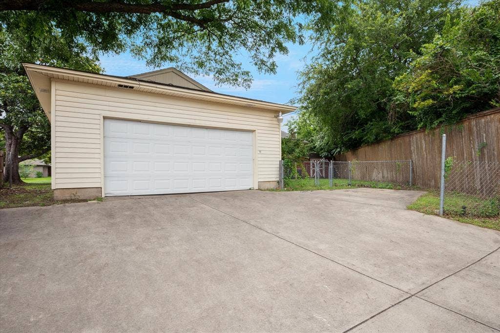 1725 Mapleton Drive, Dallas, TX 75228 Oversized, attached, rear entry garage with electrical outlets and great storage. Also an additional parking space
