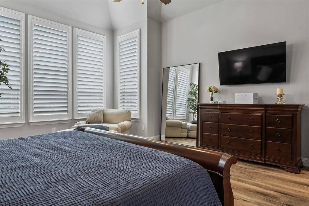 1113 12th Street, Argyle, TX 76226 Bedroom featuring light hardwood / wood-style floors, ceiling fan, and lofted ceiling
