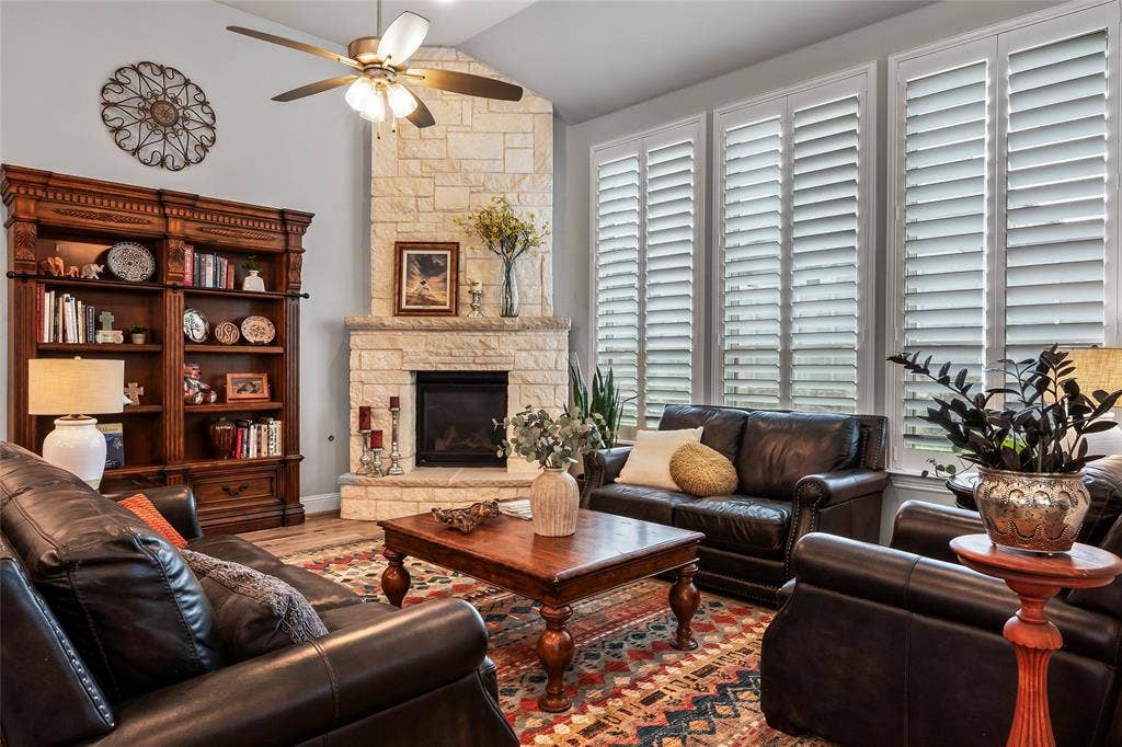 1113 12th Street, Argyle, TX 76226 Living room featuring a fireplace, a healthy amount of sunlight, ceiling fan, and lofted ceiling