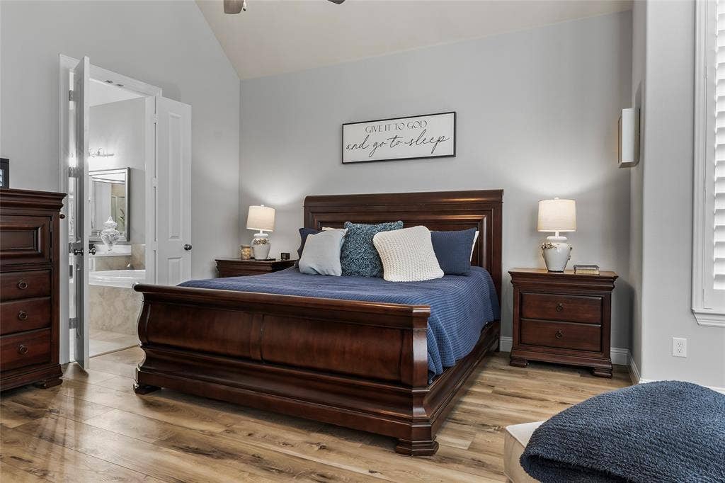 1113 12th Street, Argyle, TX 76226 Bedroom featuring connected bathroom, ceiling fan, light hardwood / wood-style floors, and vaulted ceiling
