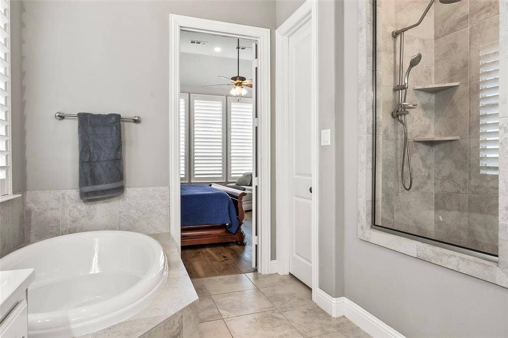 1113 12th Street, Argyle, TX 76226 Bathroom with tile patterned flooring, vanity, ceiling fan, and plus walk in shower