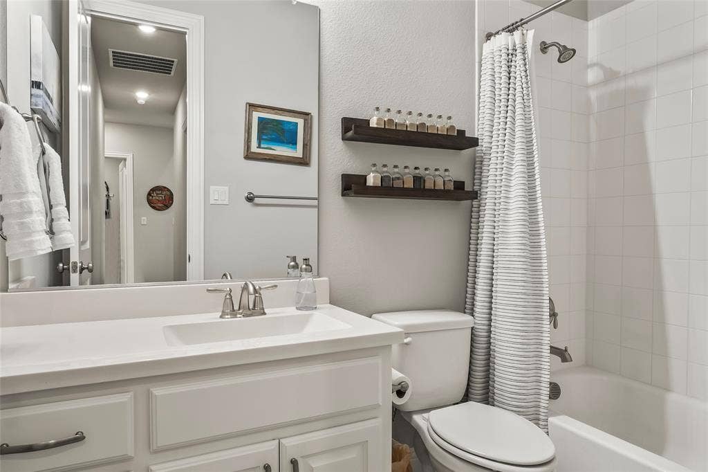 1113 12th Street, Argyle, TX 76226 Full bathroom featuring shower / bath combo, vanity, and toilet