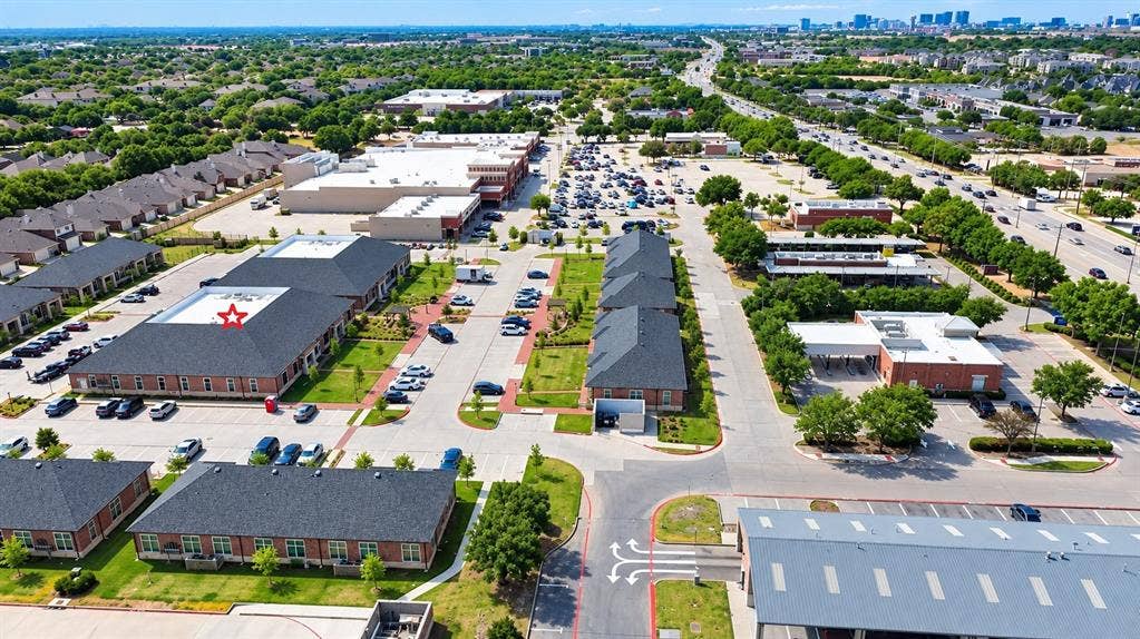 7700 Preston Rd, #1001, Frisco, TX 75035 Commercial property with multiple buildings, ample surface parking, and brick exteriors