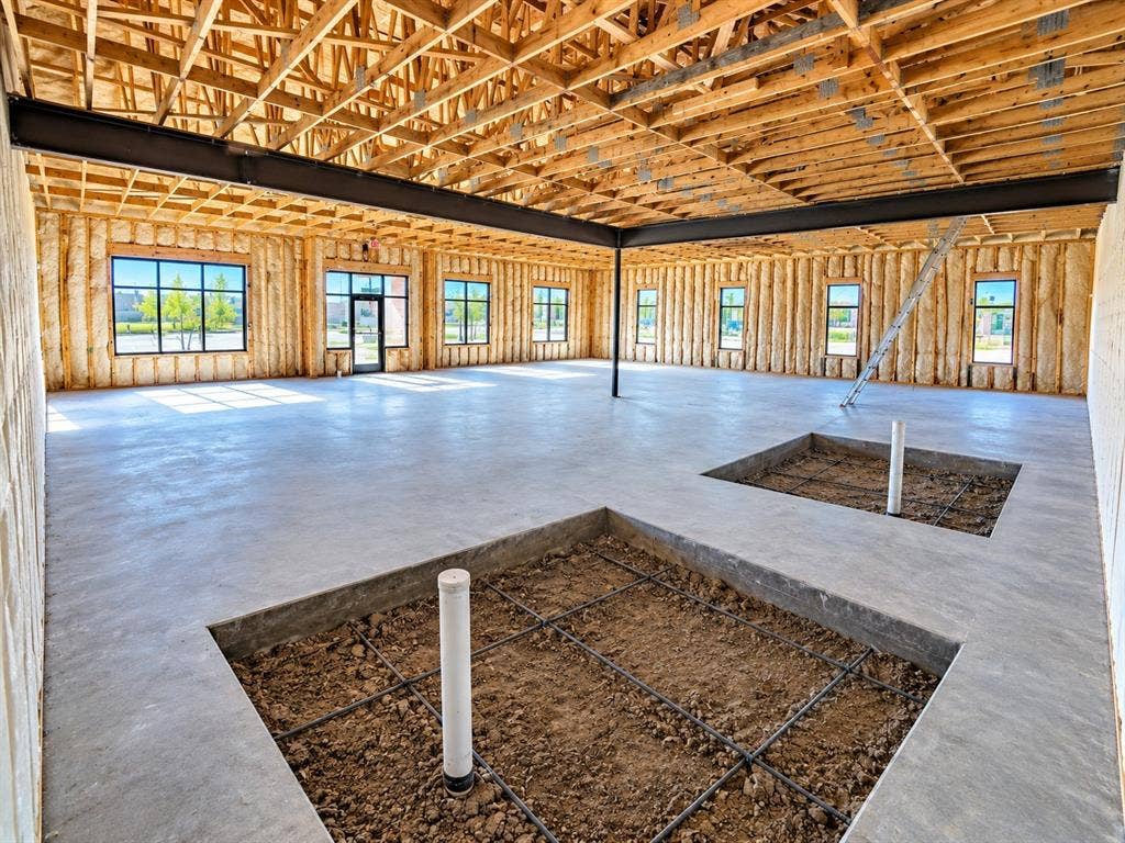 7700 Preston Rd, #1001, Frisco, TX 75035 Expansive open space with concrete flooring, exposed wood beam ceiling, and multiple large windows