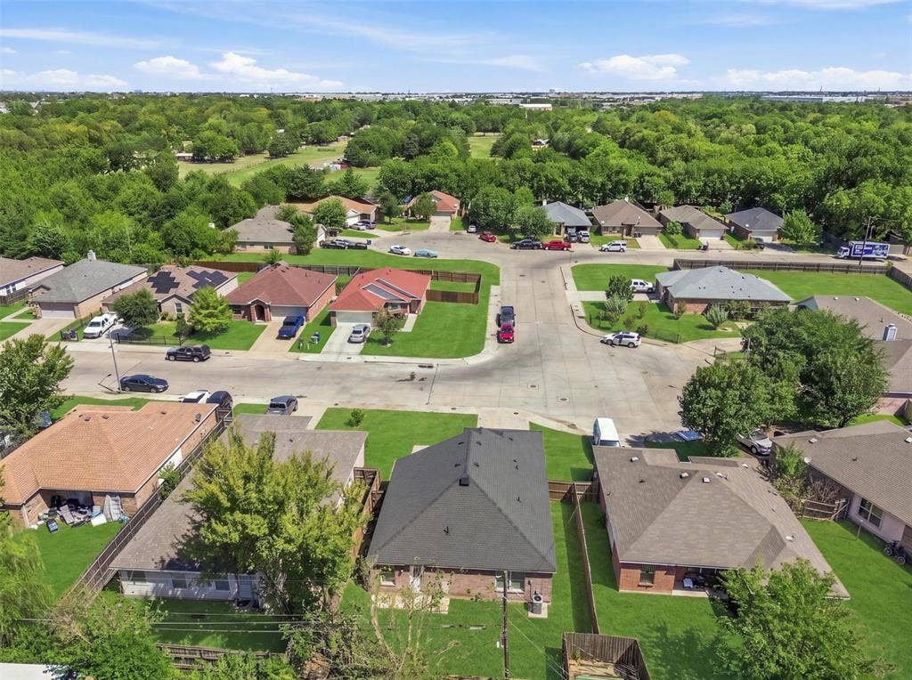 Residential neighborhood with established homes, green spaces, and mature trees