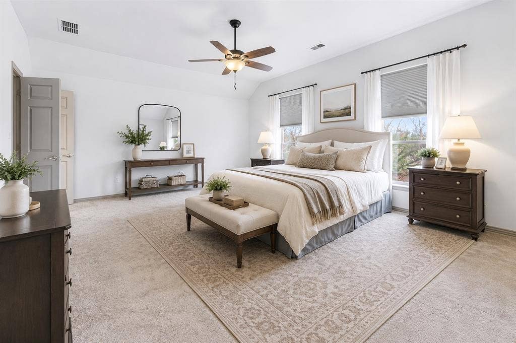 1908 Meadow Springs Drive, Haslet, TX 76052 Vaulted ceiling with a ceiling fan, two windows with blinds and curtains, and carpet flooring