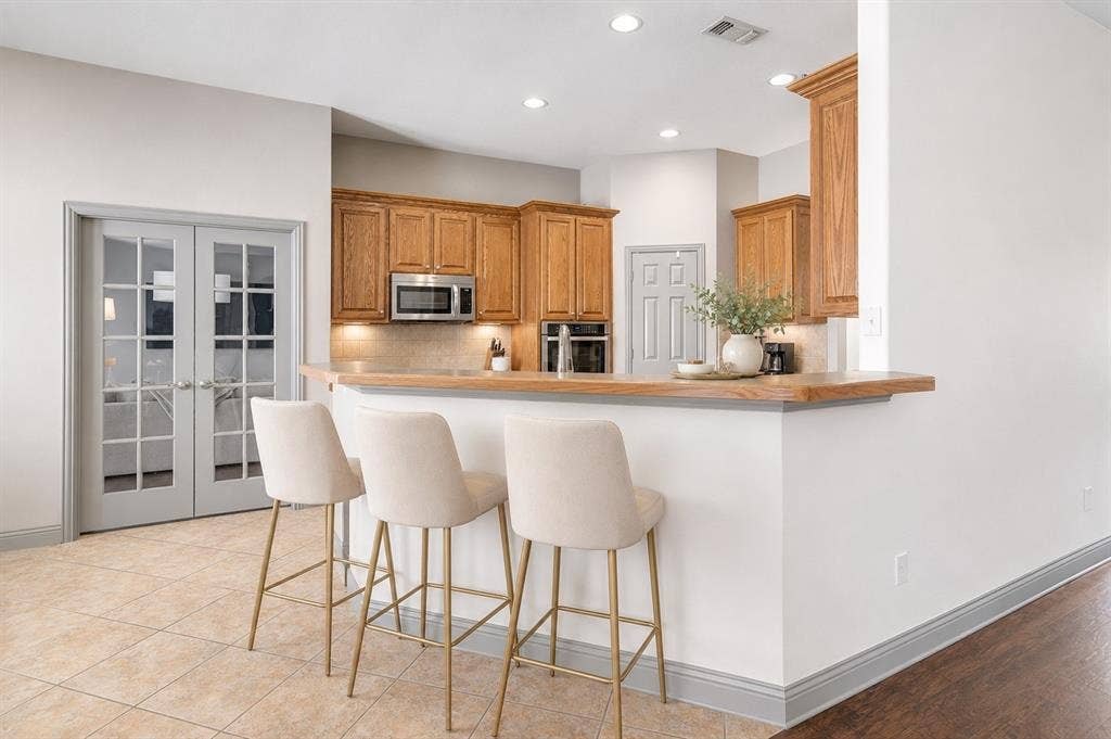 1908 Meadow Springs Drive, Haslet, TX 76052 Kitchen featuring wood-finish cabinetry, stainless steel microwave, and recessed lighting