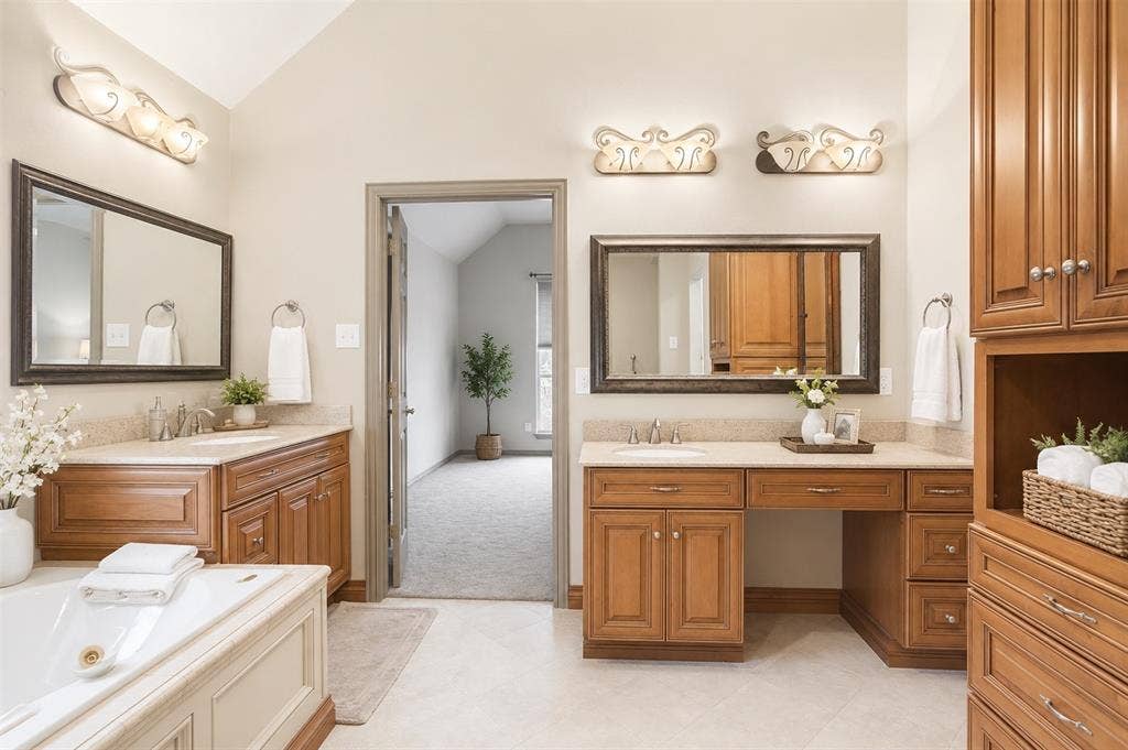 1908 Meadow Springs Drive, Haslet, TX 76052 Dual vanity sinks with under-cabinet storage, a built-in vanity desk, and a large soaking tub
