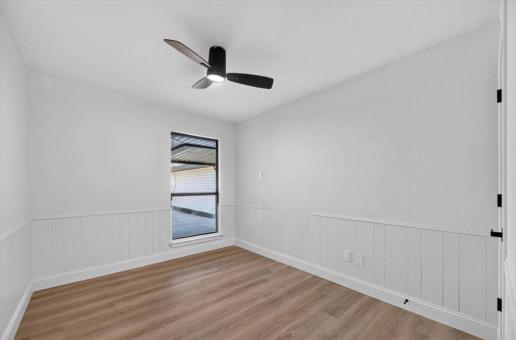 1528 Estrella Drive, Plano, TX 75074 Wood-finish flooring, white trim, off-white walls, window with blinds, and a ceiling fan with light