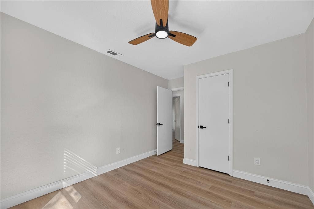 1528 Estrella Drive, Plano, TX 75074 Wood-finish flooring, white trim, off-white walls, window with blinds, and a ceiling fan with light
