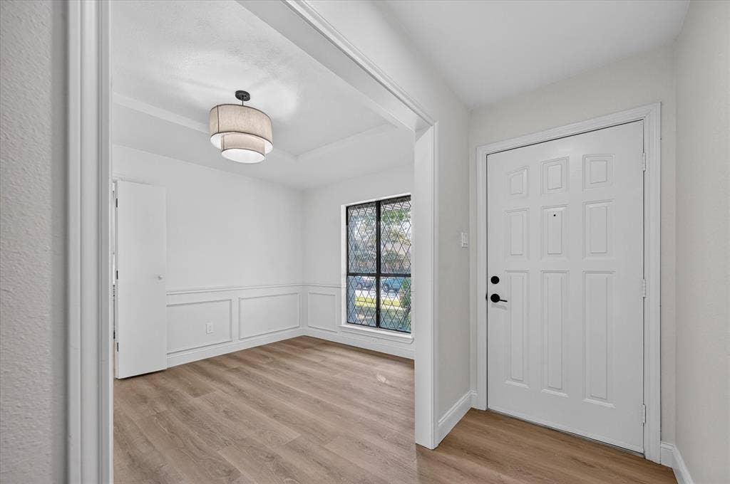 1528 Estrella Drive, Plano, TX 75074 Entryway featuring a paneled door with black hardware