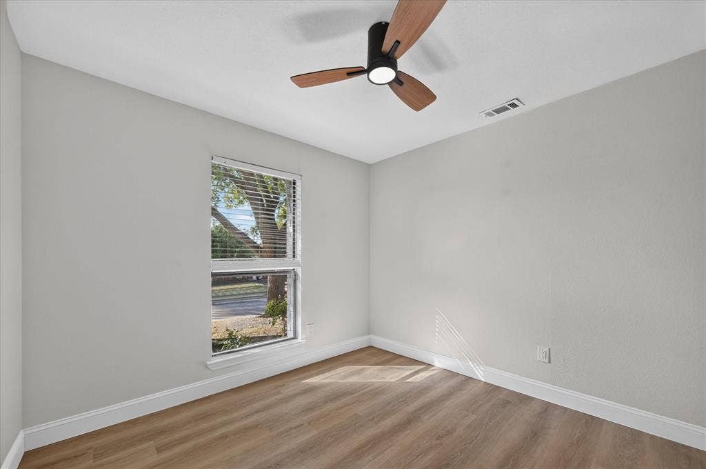 1528 Estrella Drive, Plano, TX 75074 Wood-finish flooring, white trim, off-white walls, window with blinds, and a ceiling fan with light