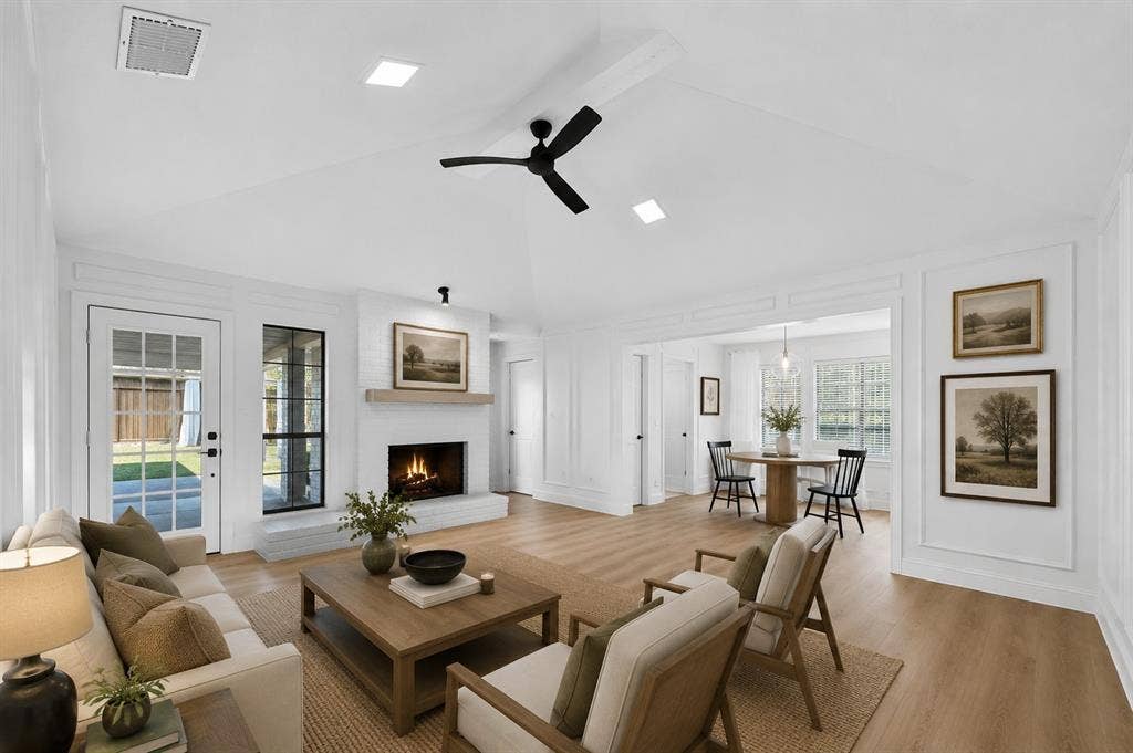 1528 Estrella Drive, Plano, TX 75074 Vaulted ceiling with a ceiling fan, recessed lighting, fireplace with a wood-finish mantel, wood-finish flooring, and a glass-paneled door