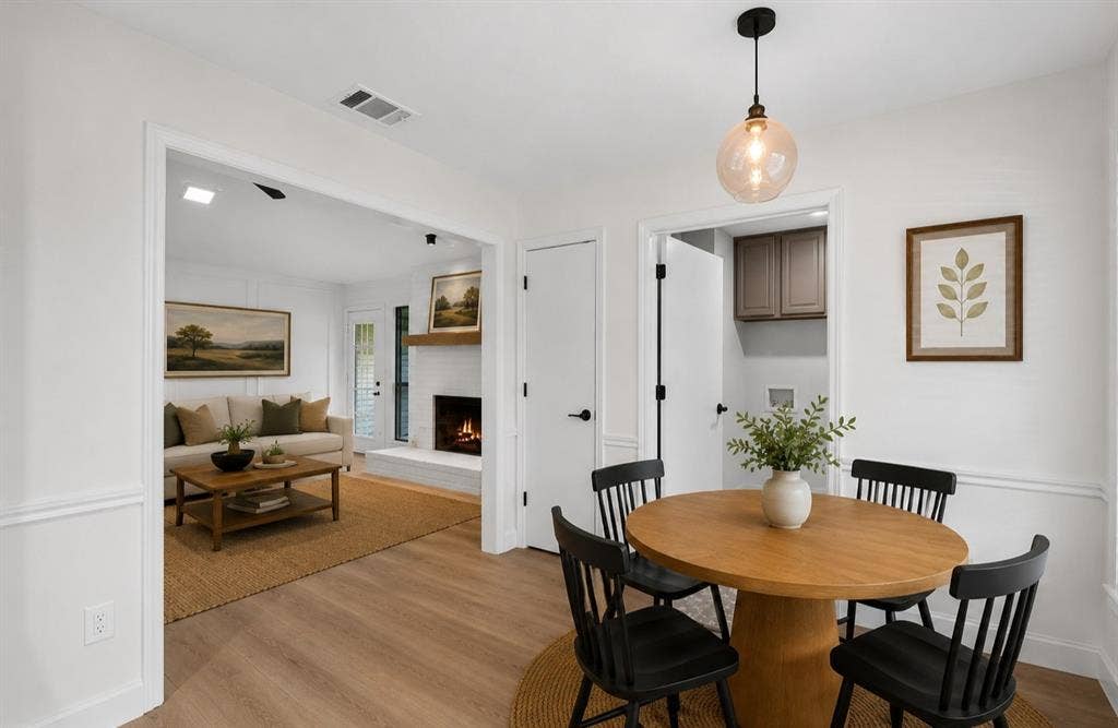 1528 Estrella Drive, Plano, TX 75074 Wood-finish flooring, wainscoting, and a spherical pendant light fixture