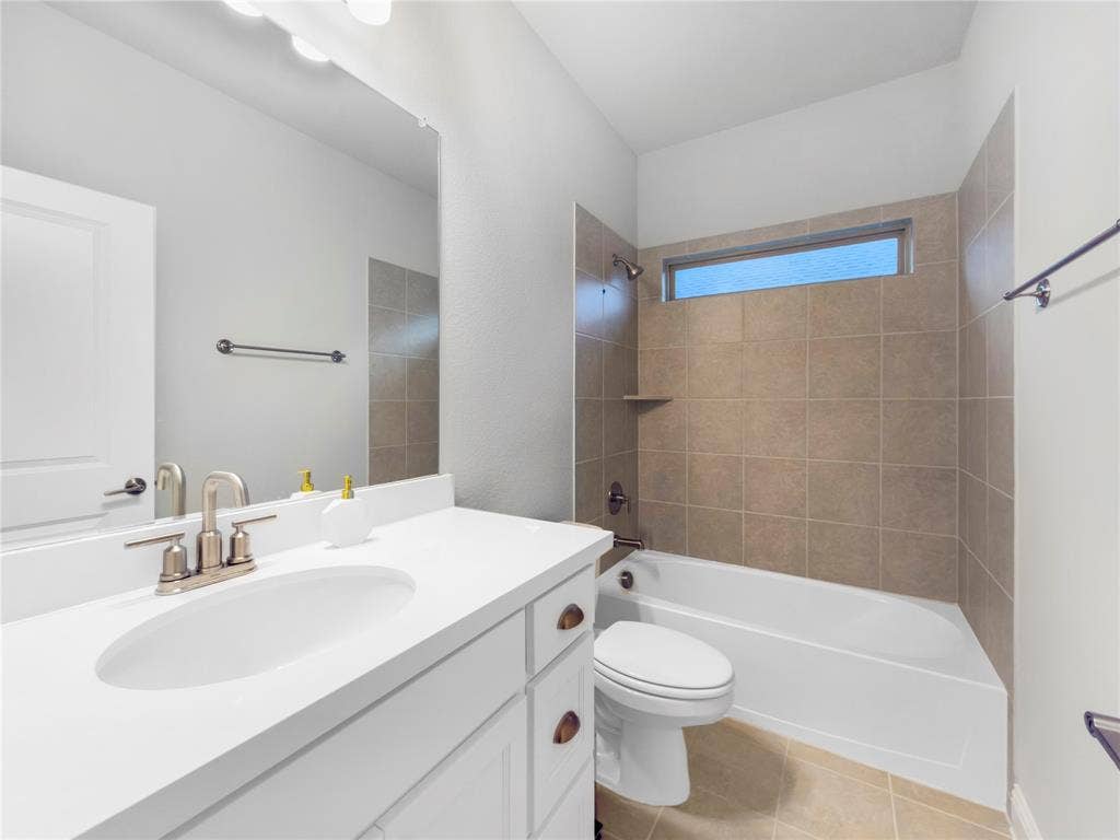 1531 20th street, Argyle, TX 76226 White vanity with integrated sink, brushed nickel faucet, large mirror, and overhead vanity lighting