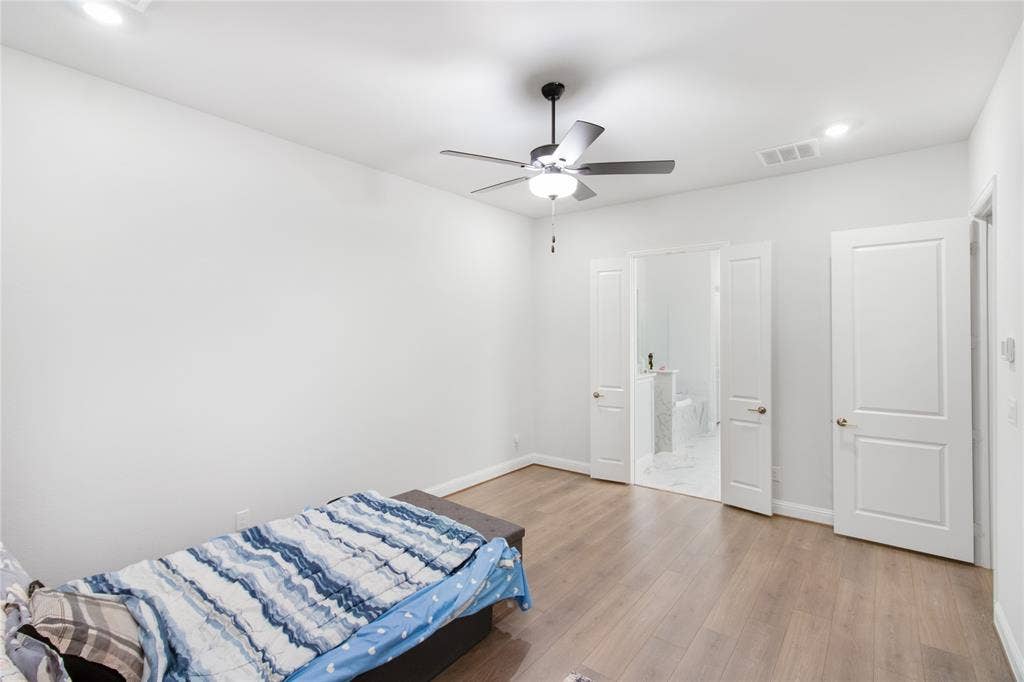 1531 20th street, Argyle, TX 76226 Wood-finish flooring, recessed lighting, ceiling fan with integrated light, and white paneled doors