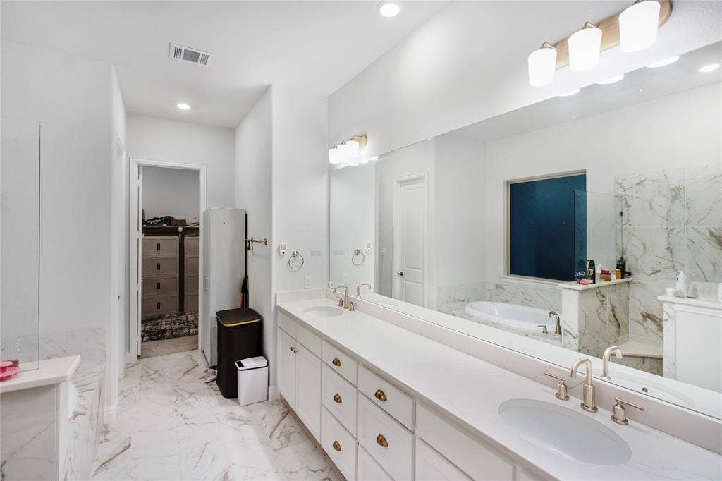 1531 20th street, Argyle, TX 76226 Dual vanity with undermount sinks, a soaking tub, and a separate shower with a glass enclosure