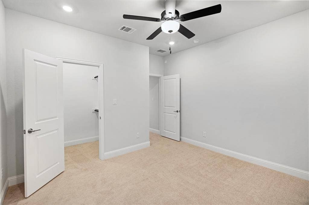 1531 20th street, Argyle, TX 76226 Bright, open bedroom featuring neutral wall finishes, warm wood-finish flooring, and abundant natural light from recessed ceiling fixtures