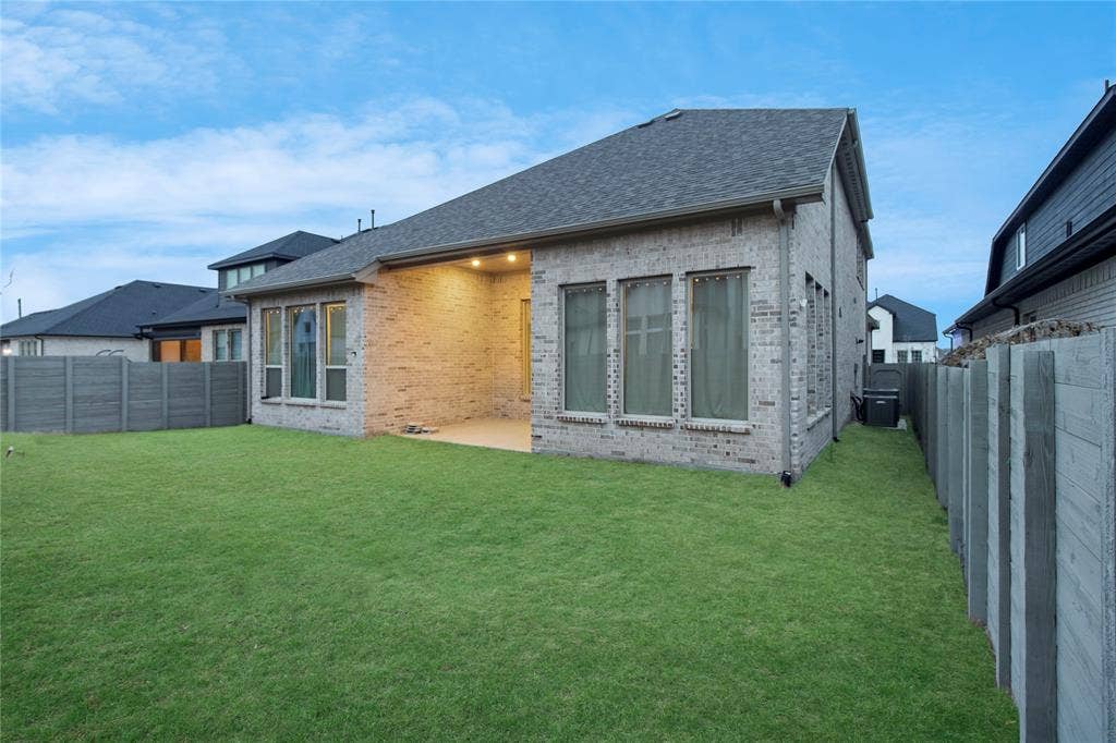 1531 20th street, Argyle, TX 76226 Expansive green lawn with a covered patio featuring recessed lighting