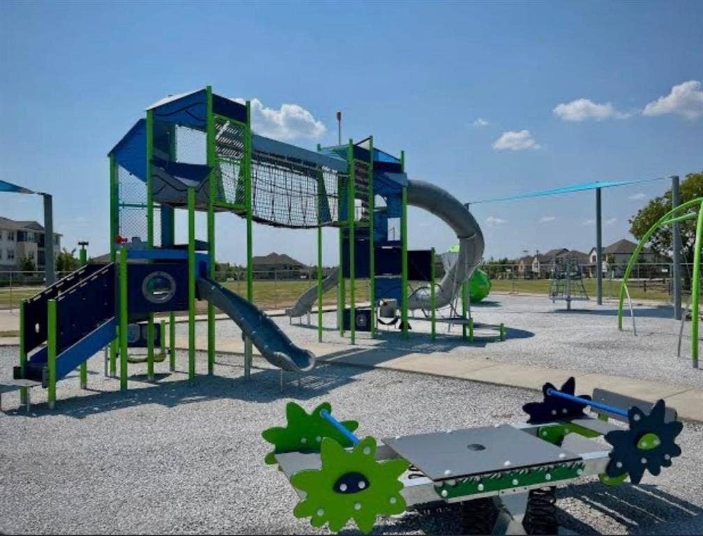 7204 Running Iron Trail, Sachse, TX 75048 Outdoor play area featuring a multi-level play structure, tube slide, open slide, and a spring rider