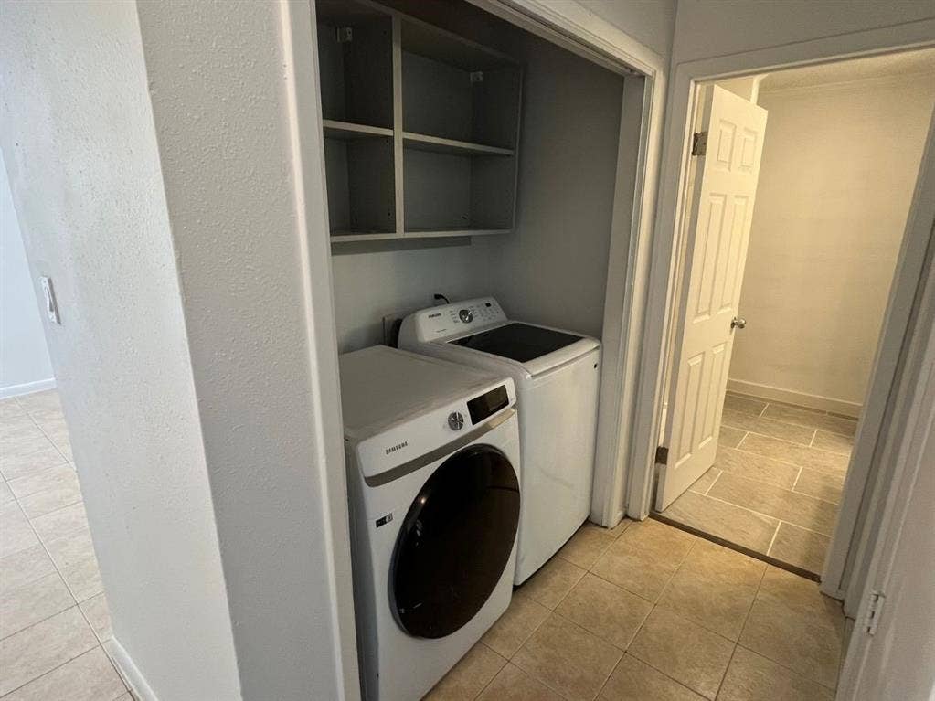 9515 Aberdeen Way, Austin, TX 78753 Laundry area featuring built-in shelving, a front-load washer, and a top-load dryer, with tiled flooring