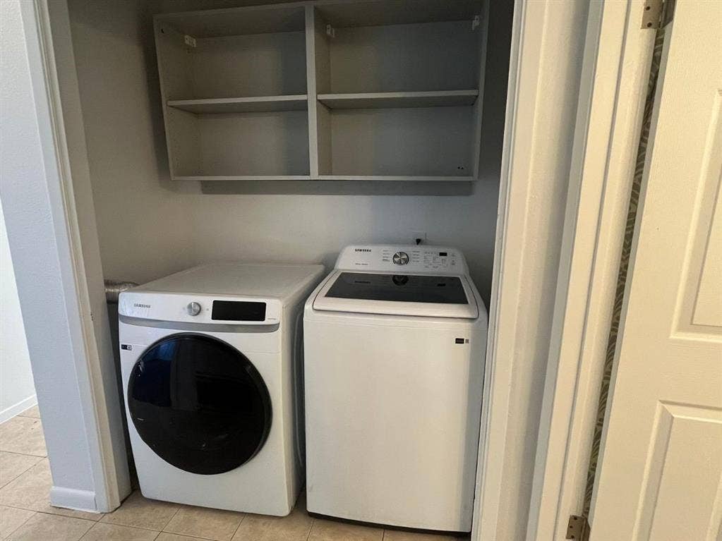 9515 Aberdeen Way, Austin, TX 78753 Laundry area featuring a front-load washer, top-load dryer, and wall-mounted shelving