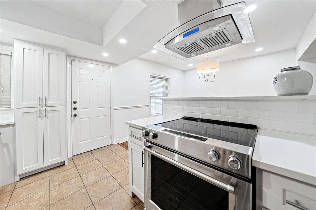 6435 Oriole Drive, #6435, Dallas, TX 75209 Stylish chimney style vent presides over the stainless steel electric range.