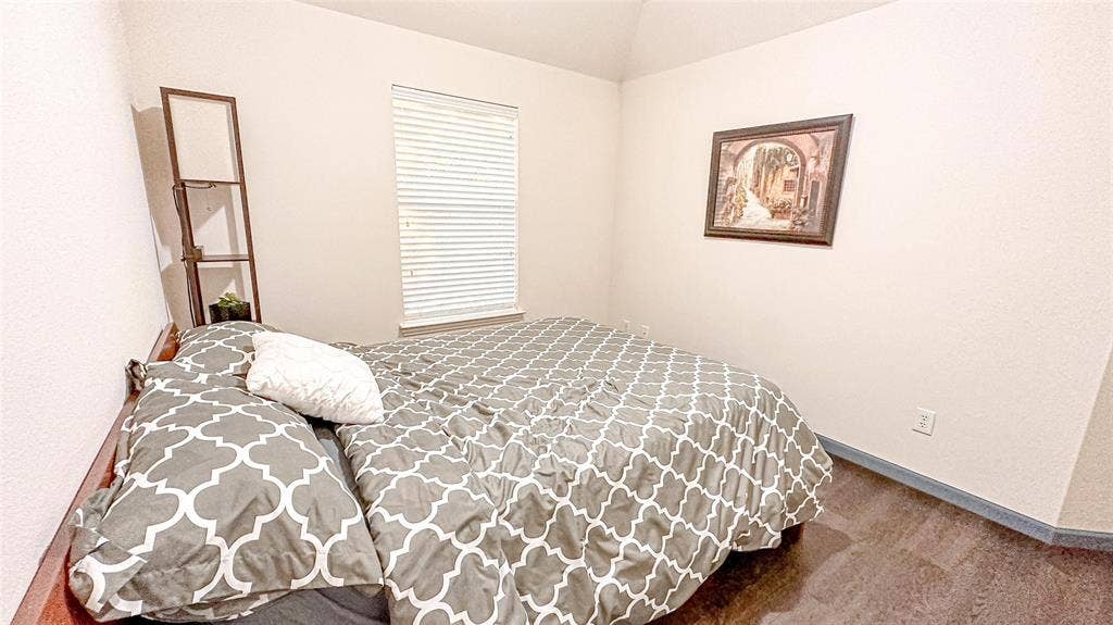 12146 Gonzales Drive, Frisco, TX 75035 Carpeted bedroom with lofted ceiling