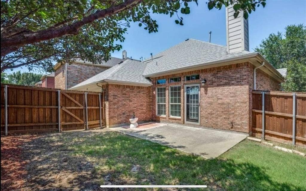 12146 Gonzales Drive, Frisco, TX 75035 Rear view of house featuring fence, a patio, brick siding, a gate, and roof with shingles