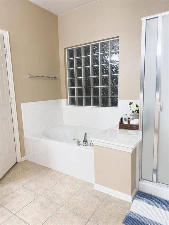 12146 Gonzales Drive, Frisco, TX 75035 Bathroom with a shower stall, a bath, and tile patterned floors