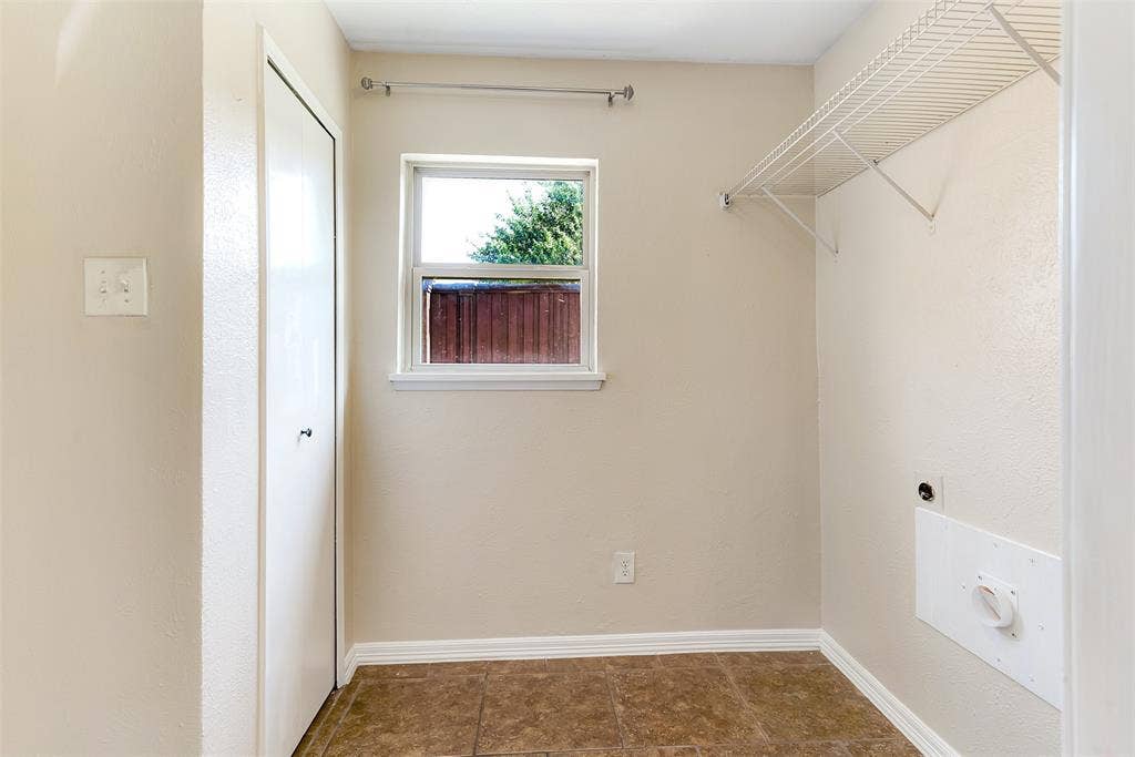 925 Lombardy Drive, Plano, TX 75023 Tiled flooring, white trim, single window, wire shelving, and a bi-fold door